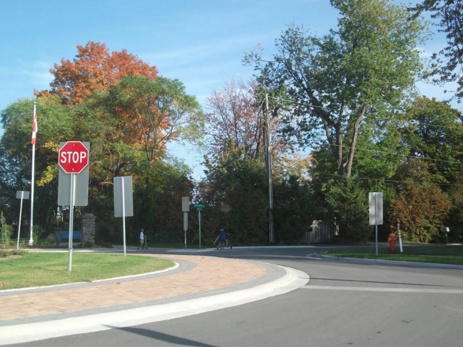 A quiet Ontario roundabout with a stop sign, the kind of everyday intersection the rules-of-the-road section covers
