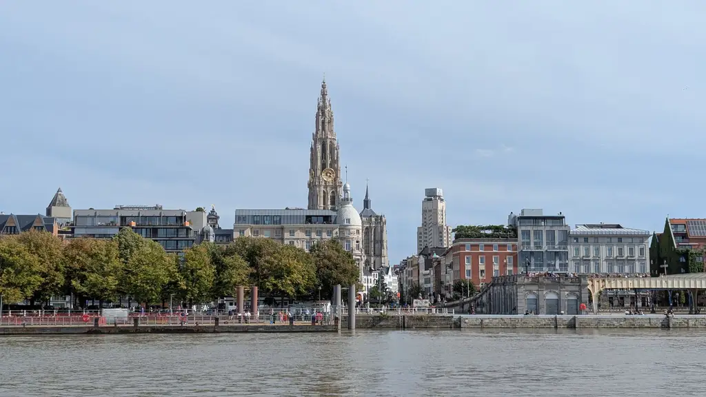 Capture of Antwerp city skyline featuring the Cathedral of Our Lady on a sunny day.