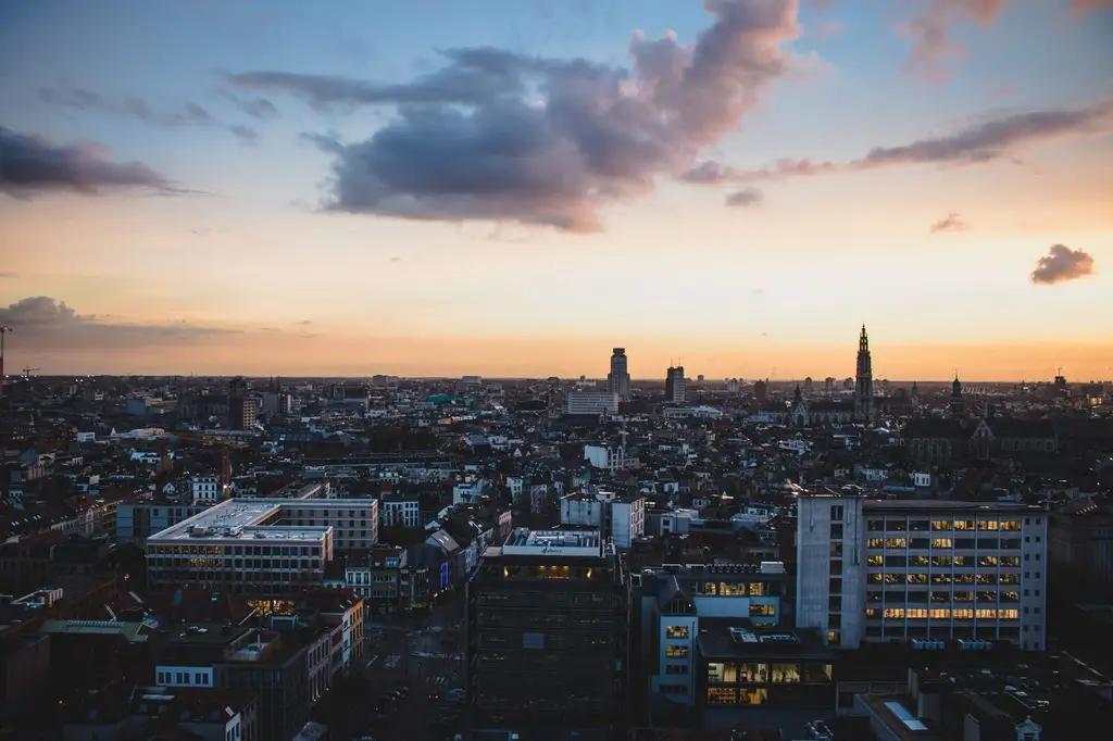 A stunning aerial view of Antwerp, Belgium, cityscape at dusk with vibrant sky colors.