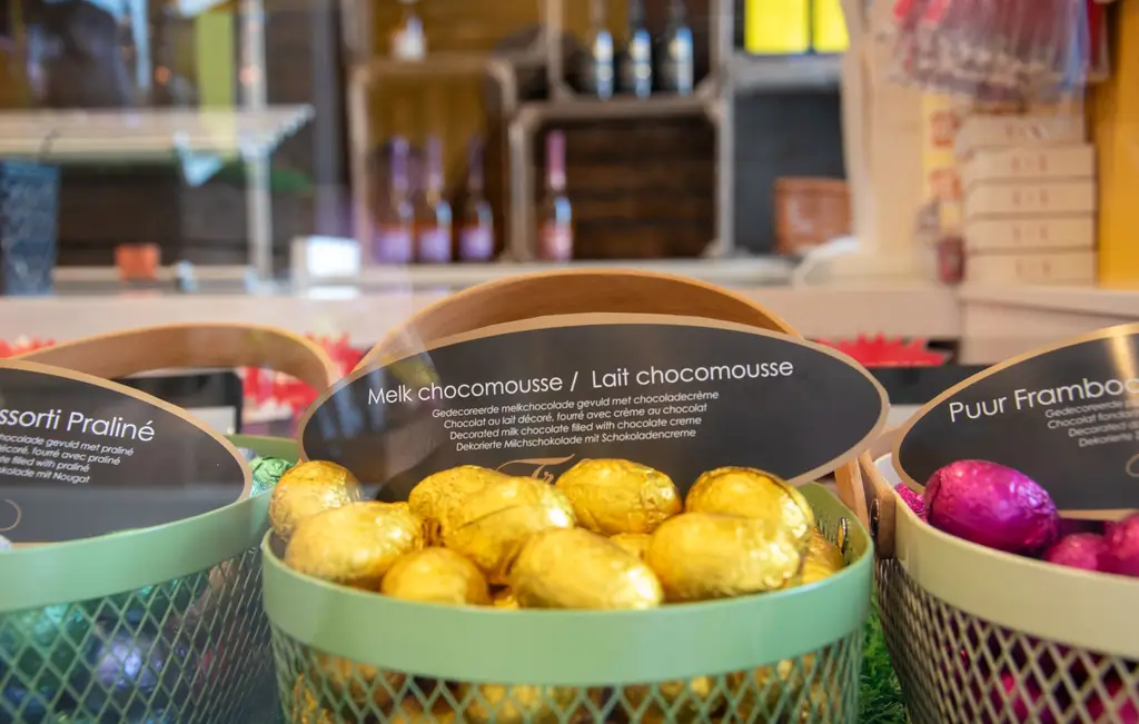 Decorative display of assorted Belgian chocolate eggs in a confectionary shop.