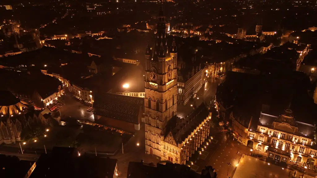 Stunning aerial view of Ghent, Belgium at night showcasing the illuminated Belfry and historic architecture.