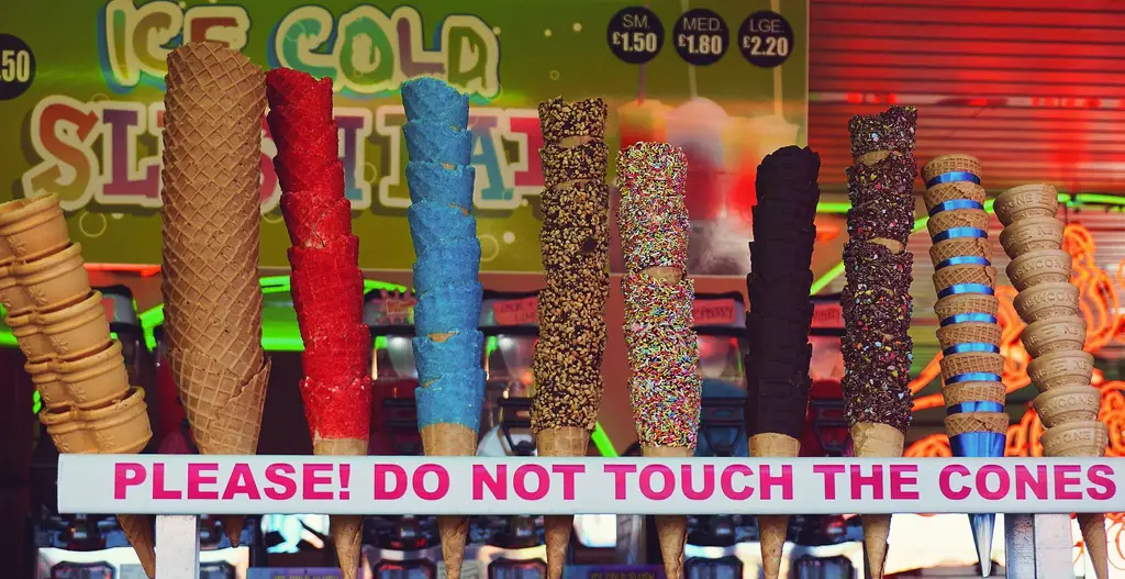 A playful assortment of colorful ice cream cones displayed at a vibrant stall.