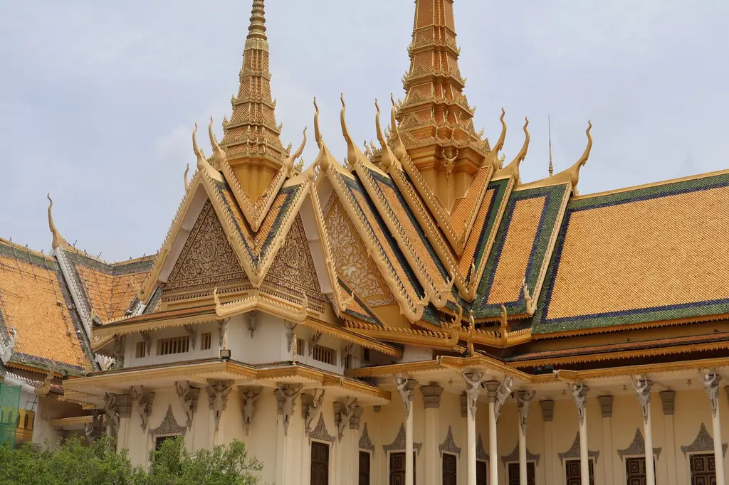Intricate architecture of the Royal Palace in Phnom Penh with golden spires and detailed carvings.