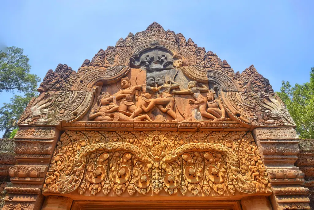 Detailed view of stone carvings at Banteay Srei Temple, showcasing Hindu mythology.