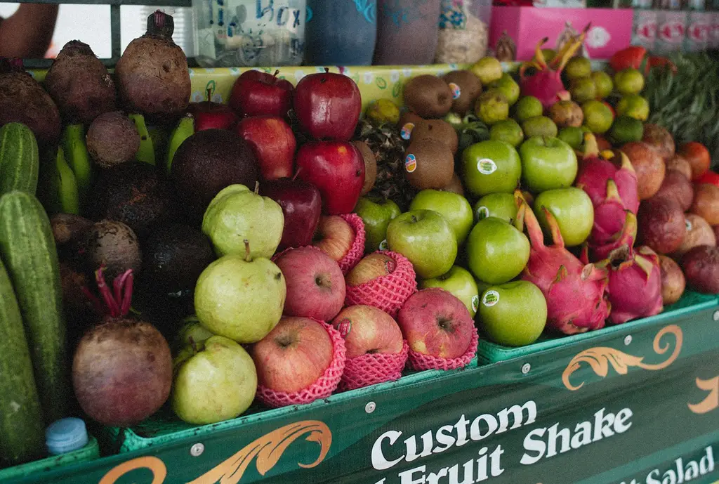 A vibrant assortment of fresh fruits at an outdoor market offering custom fruit shakes.