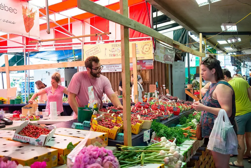 Bustling farmers market with fresh fruits, vegetables and people exploring vibrant stalls.