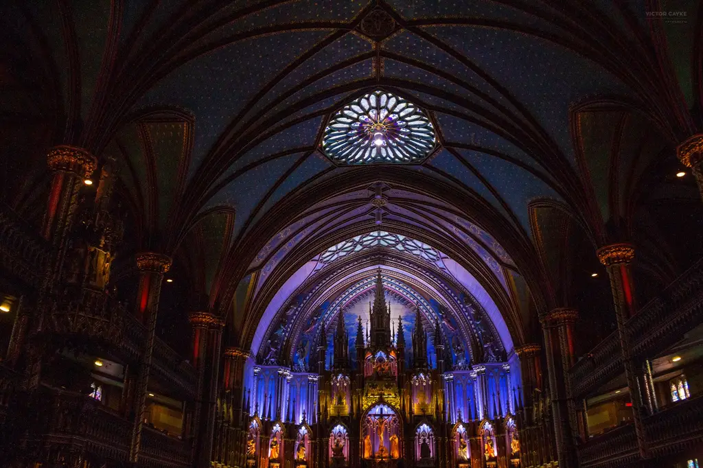 Stunning view of Notre-Dame Basilica's ornate interior in multiple colors, Montreal, Canada.