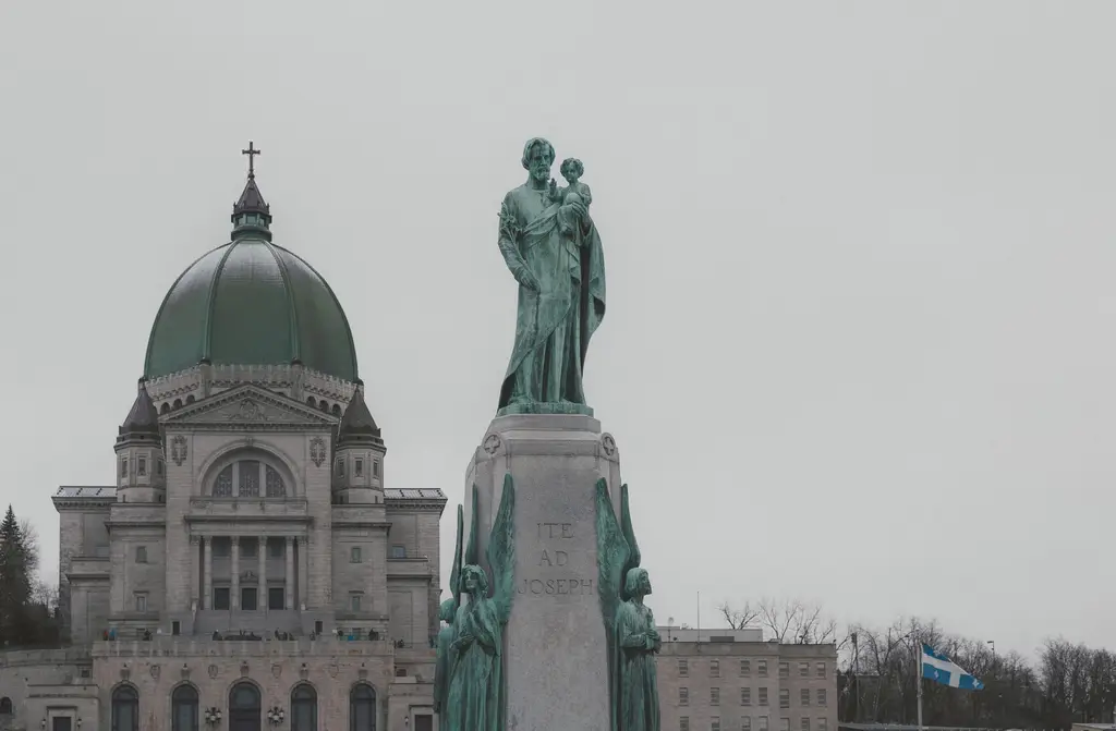 View of Saint Joseph's Oratory and statue in Montreal, Canada, on a cloudy day.