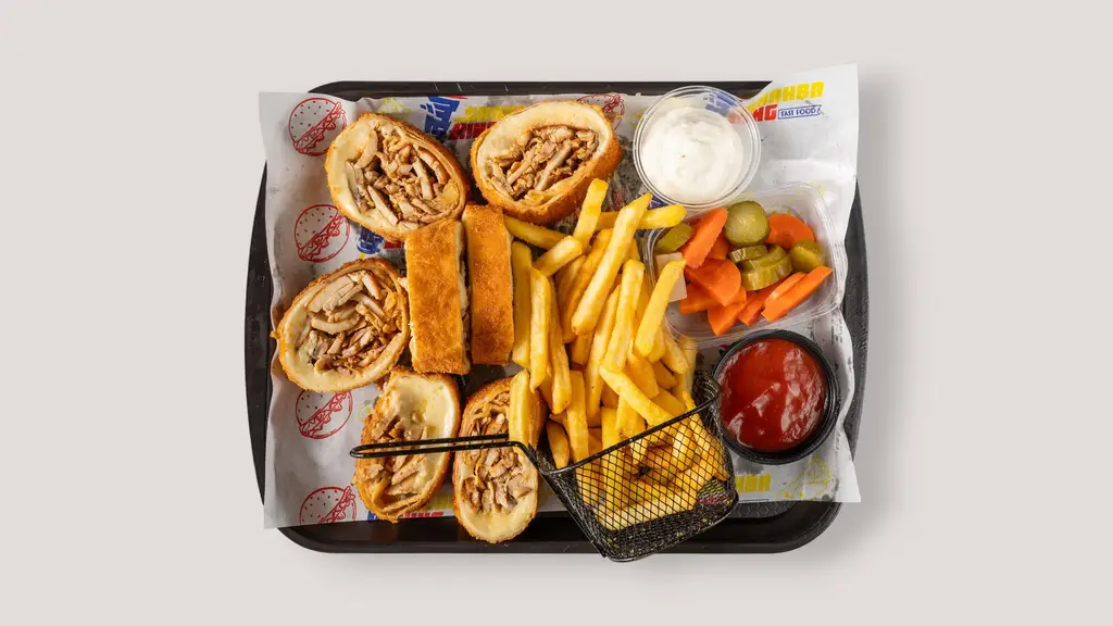 Tasty shawarma wraps served with crispy fries, assorted pickles, and savory dips, perfect for a delightful meal.
