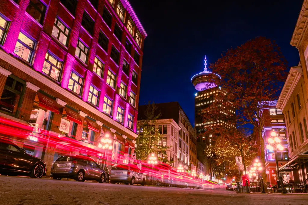 Captivating long exposure of vibrant Vancouver streetlights and architecture during the night.