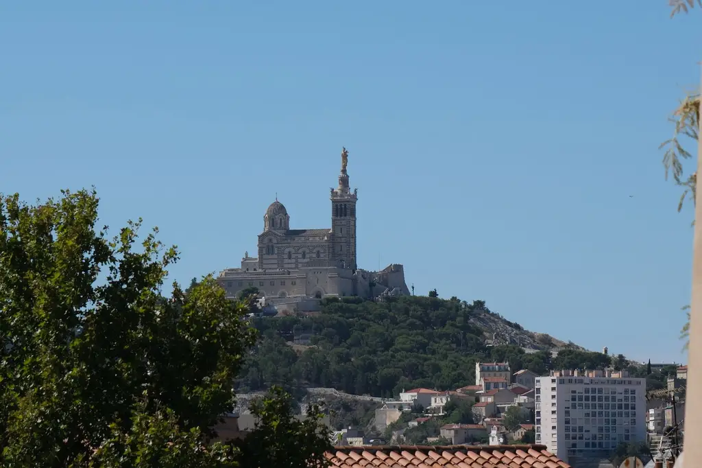 A clear view of Notre-Dame de la Garde basilica on a hill in Marseille, France.