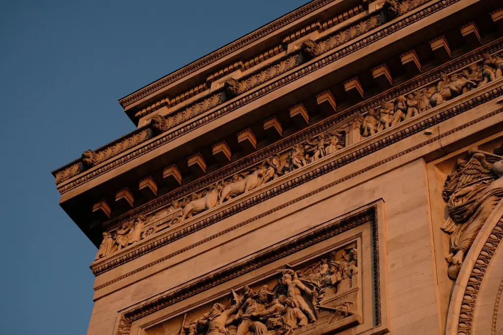 Detailed view of the ornate carvings on the Arc de Triomphe, Paris, showcasing classic architectural elements.
