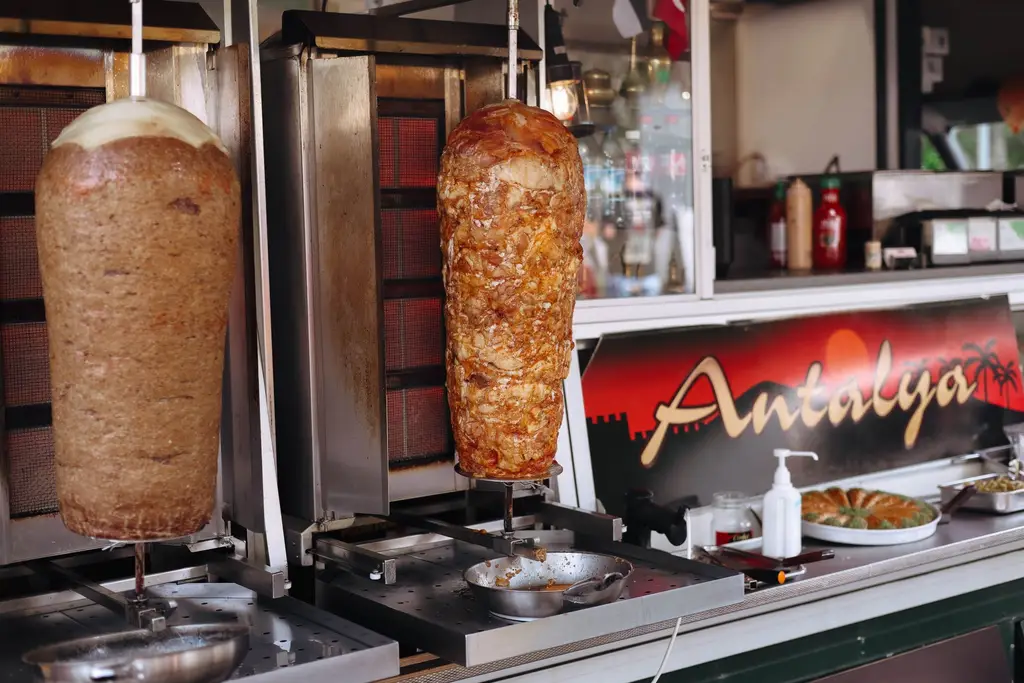 Authentic shawarma rotating on spits in a street food stall in Antalya. Perfect Turkish culinary experience.