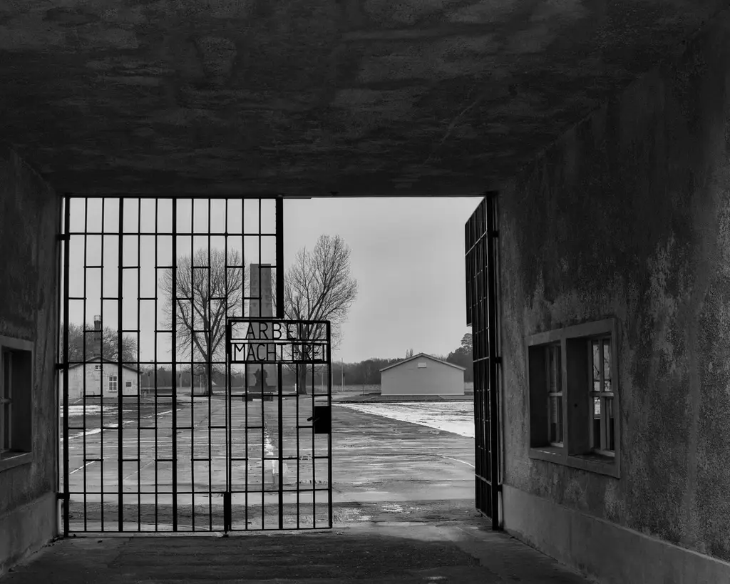 Black and white view of Sachsenhausen Memorial gate in Oranienburg, Germany.