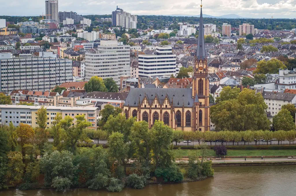 Aerial image capturing Frankfurt with St. Bartholomew's Cathedral and urban skyline.