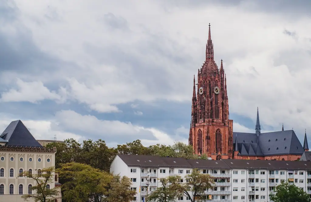 View of Frankfurt Cathedral, Gothic architecture, under a cloudy sky.