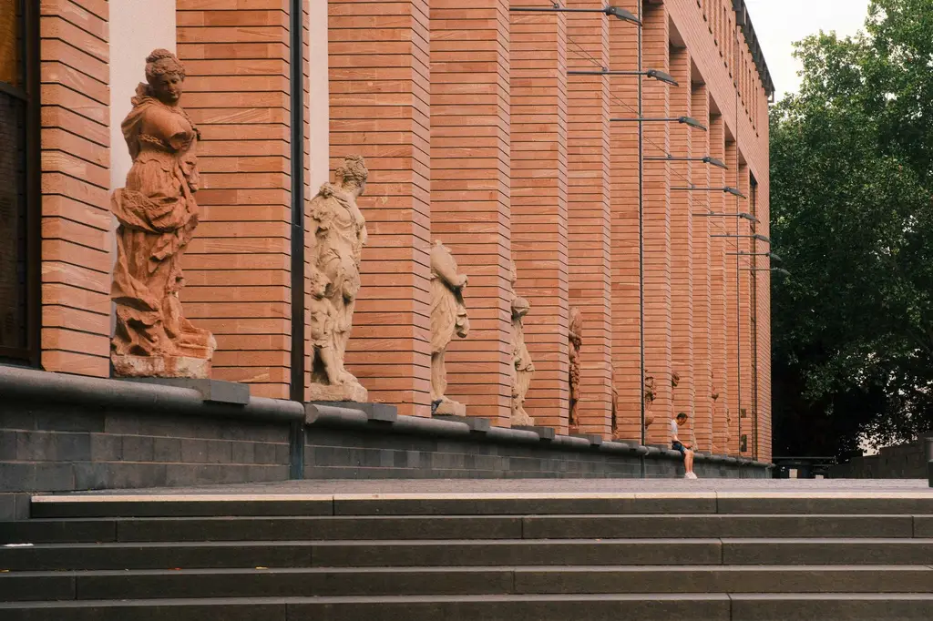 Brick building facade with statues in Frankfurt, Germany, showcasing classic architectural features.