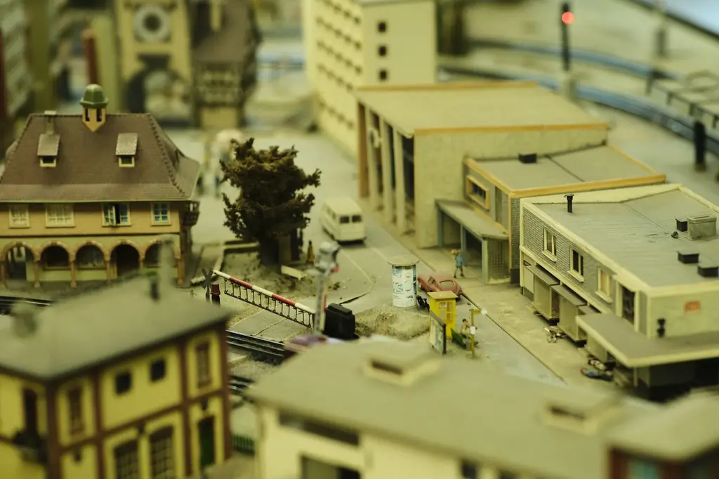 Intricate model town showcasing buildings and a railway track in a miniature setting.