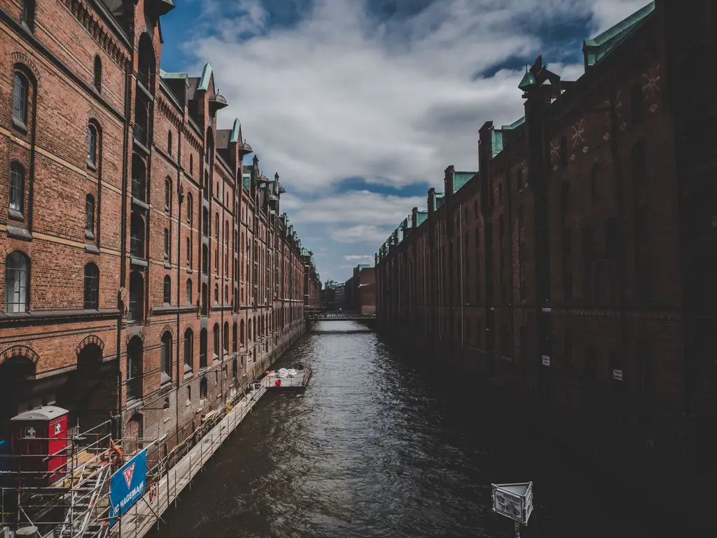 Explore the historic Speicherstadt district in Hamburg, showcasing its iconic red brick warehouses and canals.