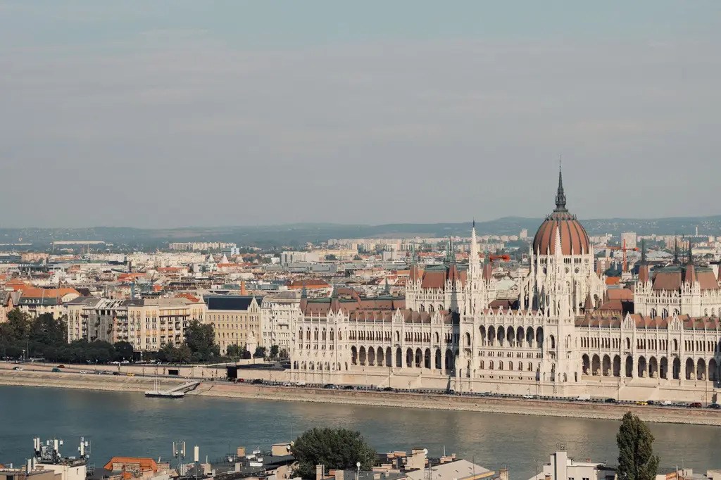 Scenic view of the iconic Hungarian Parliament Building along the Danube River in Budapest.