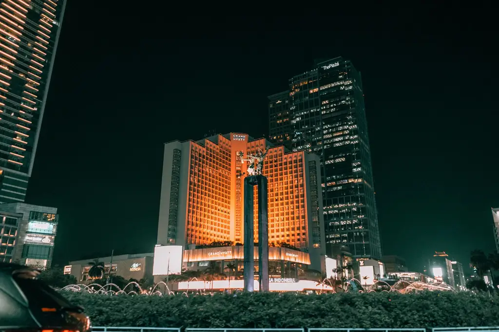 Urban nightscape featuring iconic Plaza Indonesia and landmark in Jakarta, Indonesia.