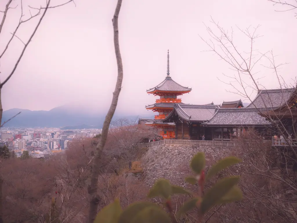 Kiyomizu-dera Temple in Kyoto during winter, showcasing traditional Japanese architecture with a misty backdrop.