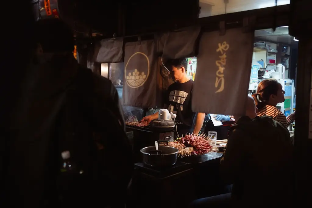 A group of people sitting at a table in a restaurant
