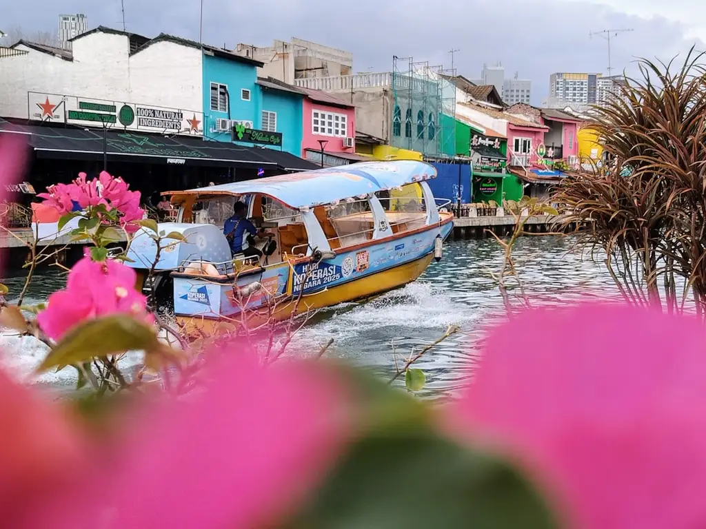 Boat on a canal passing colorful buildings