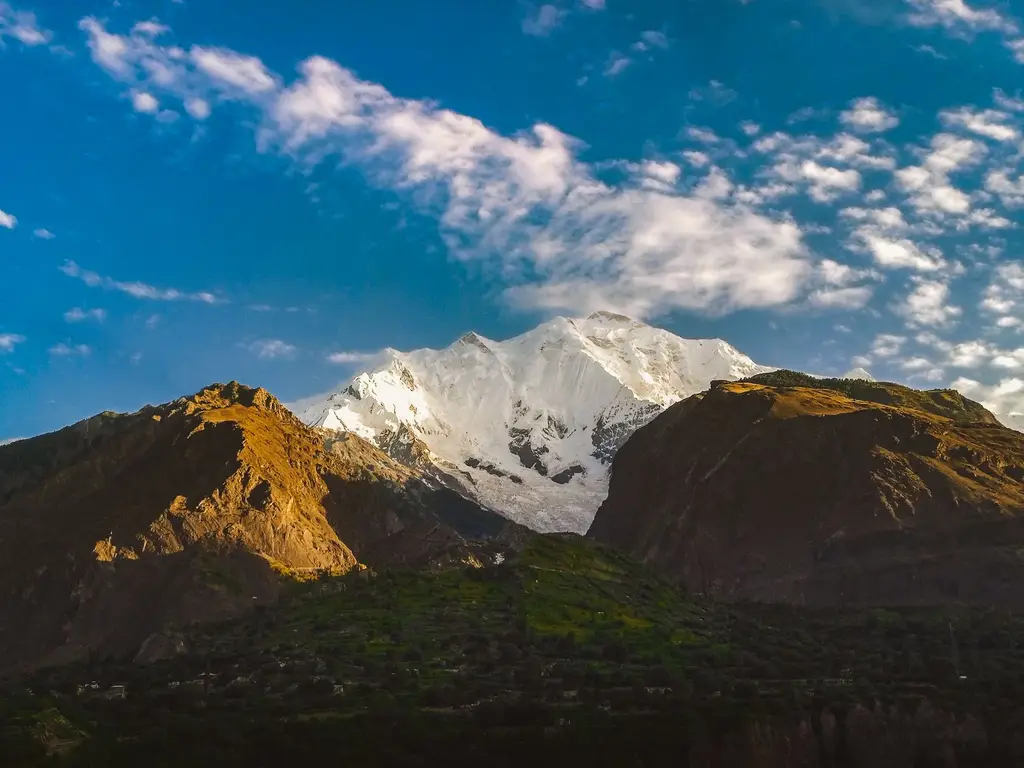 Stunning view of snow-capped Rakaposhi amidst a clear blue sky, Hunza Valley, Pakistan.