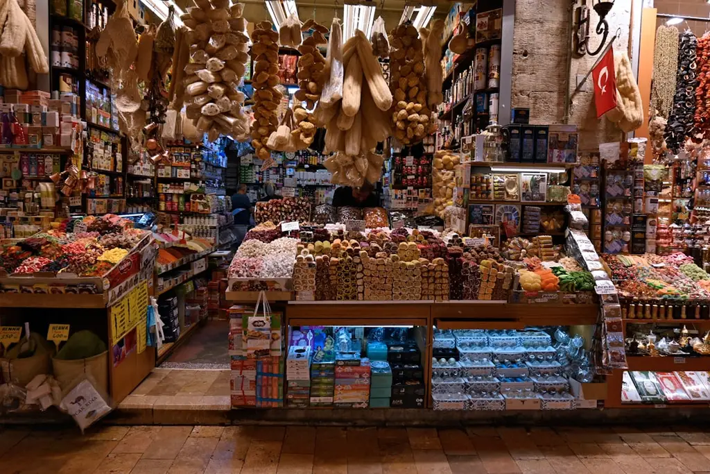 Turkish market stall displaying dried vegetables, nuts, and candies