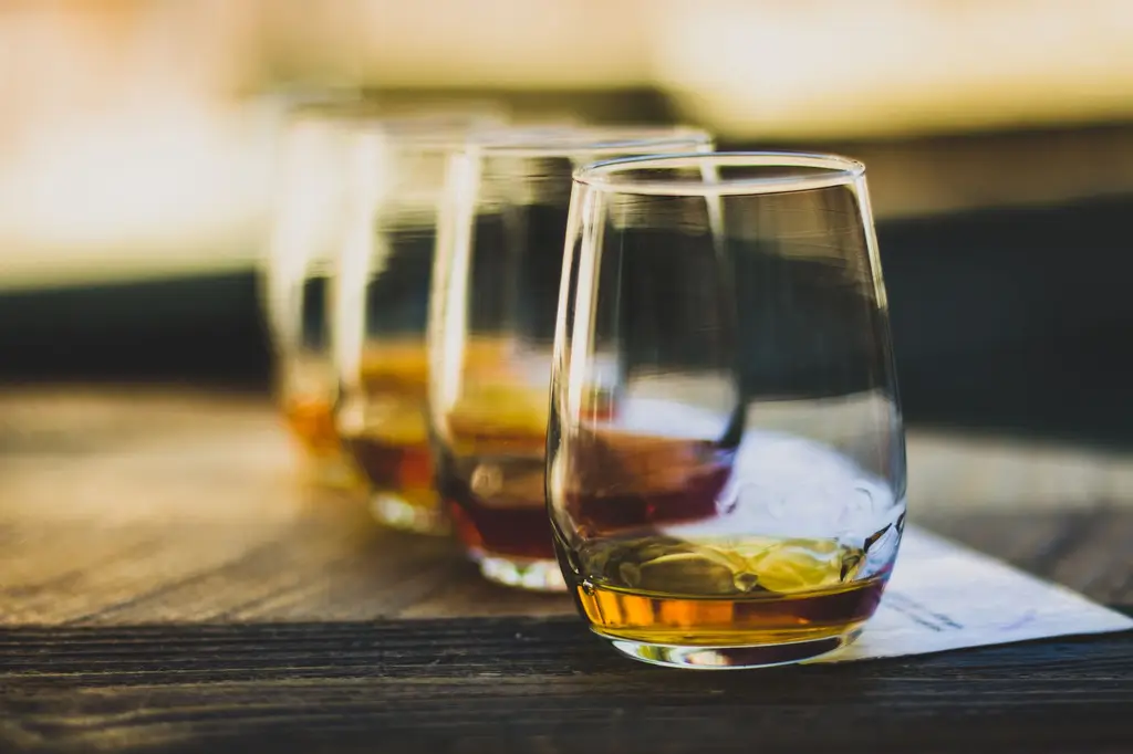 Elegant close-up of whisky glasses in a luxurious tasting setup, highlighting rich tones and textures.