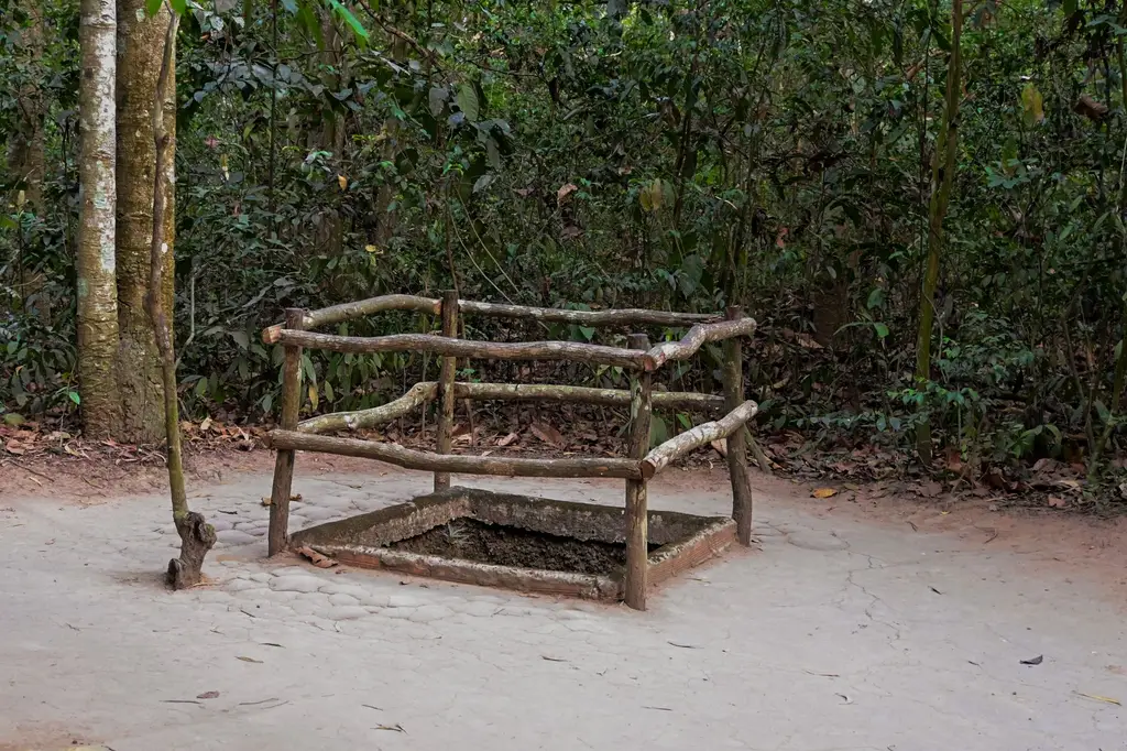 Entrance to the historic Cu Chi Tunnels in Vietnam, surrounded by lush forest.