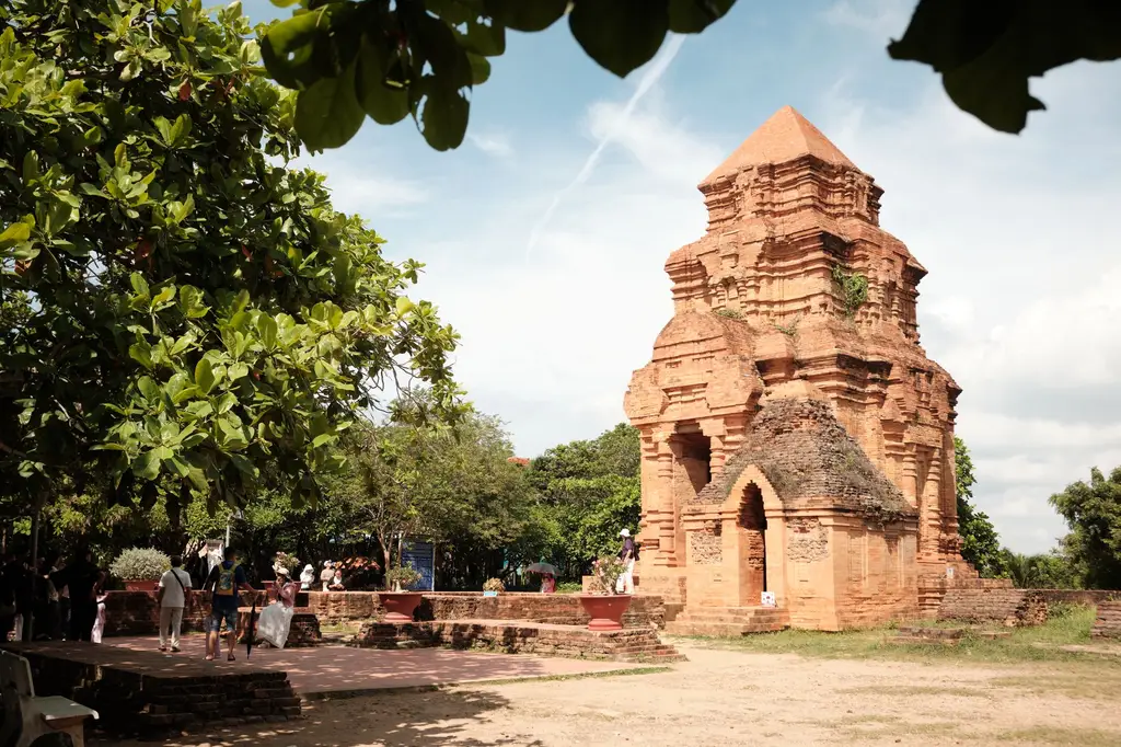 Explore the ancient red brick temple surrounded by lush green trees in Phu Thuy, Vietnam.