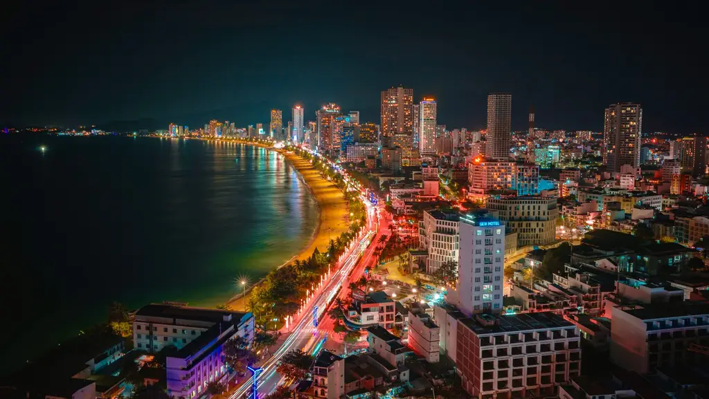 Aerial view of the illuminated coastline and cityscape of Nha Trang, Vietnam at night.