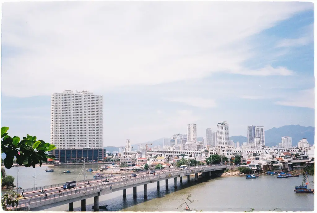 Expansive cityscape view of Nha Trang's modern skyline under a bright summer sky.